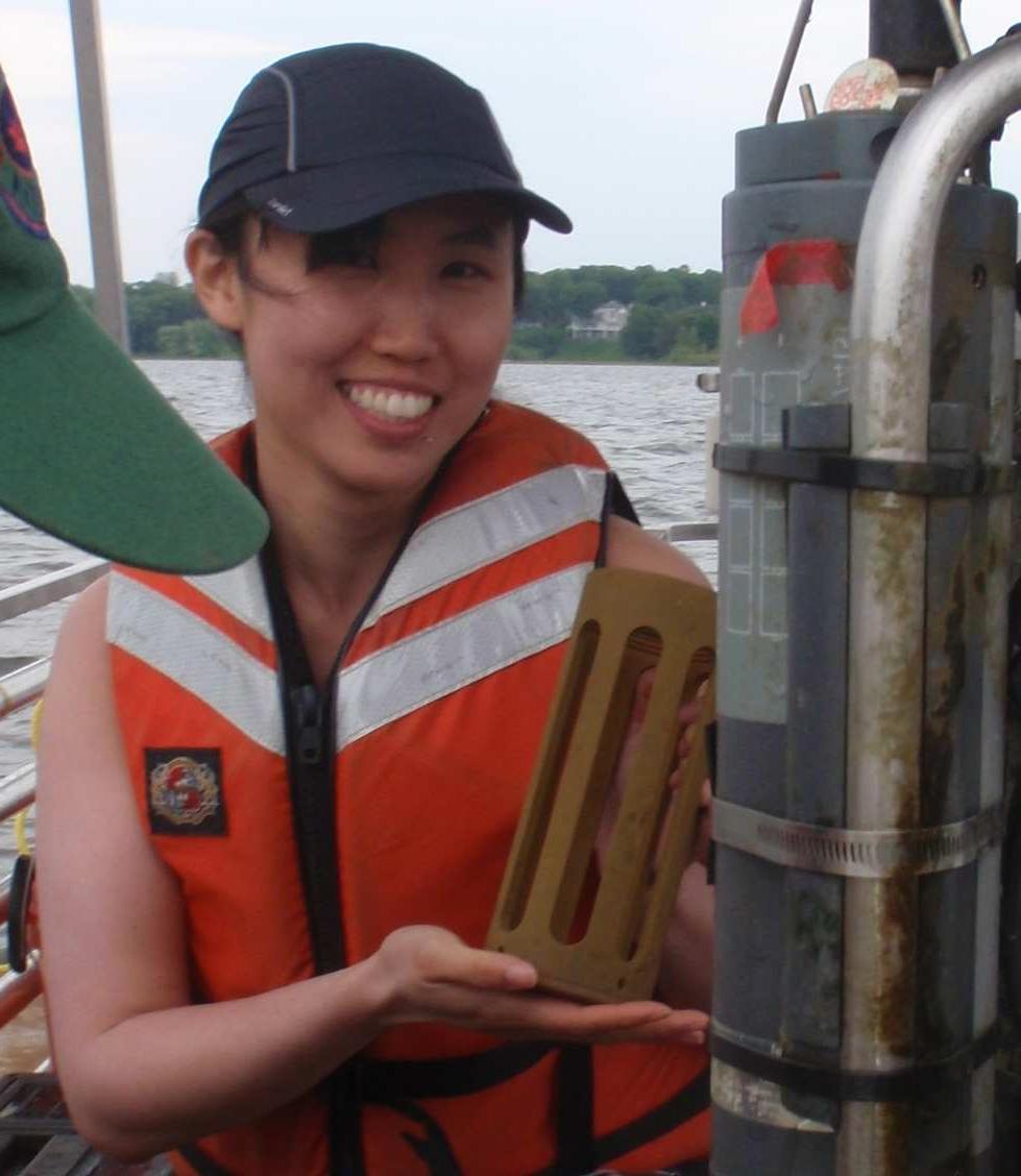 Vingie Ng holds a sonde cage next to subsurface sensors